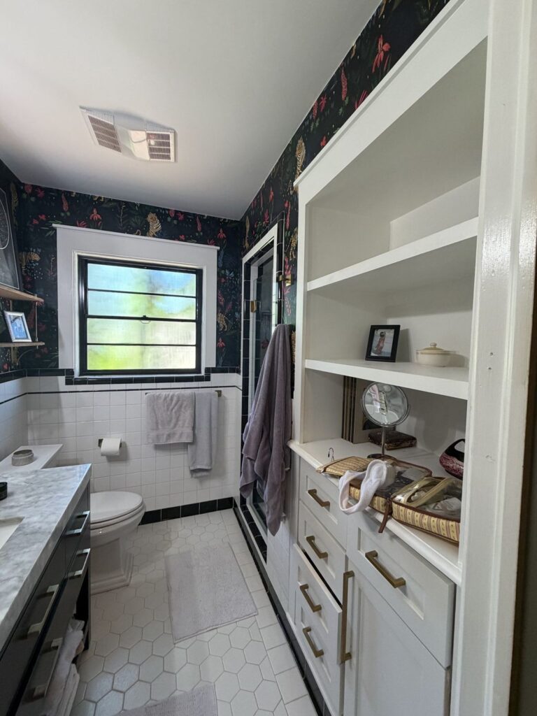 Before: white built-in shelving and cabinets across from the vanity